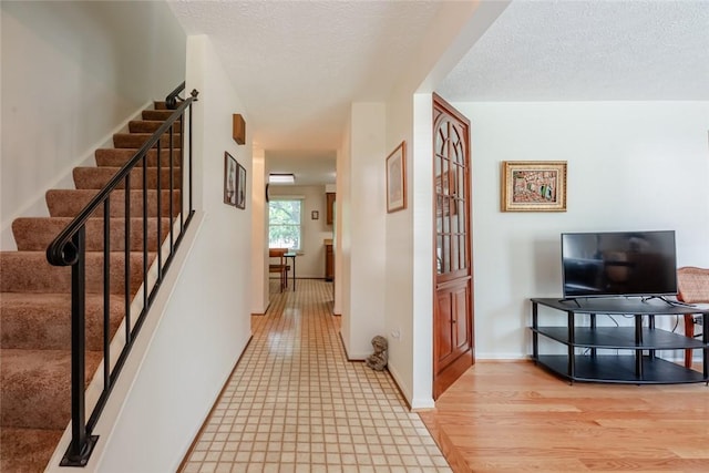 11 Brightwoods Ln, Brighton, NY 14623 - corridor with stairs and a textured ceiling