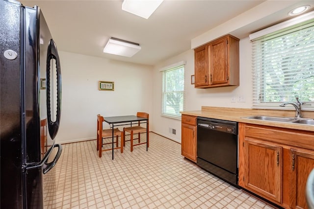 11 Brightwoods Ln, Brighton, NY 14623 - kitchen featuring black appliances, a sink, light floors, and healthy amount of natural light
