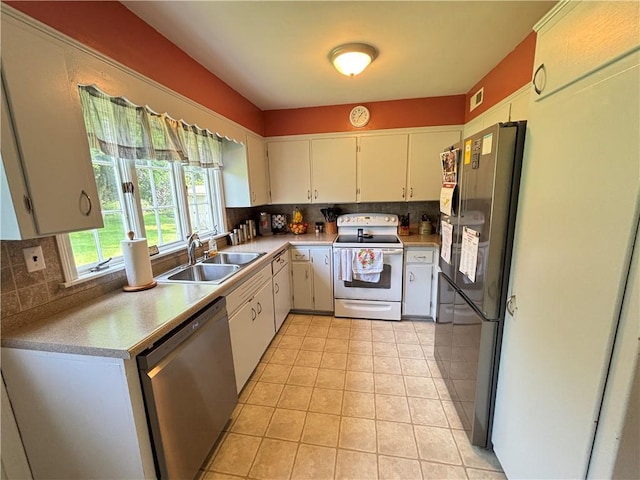 46 Dickerson St, Lyons, NY 14489 - kitchen with white electric range, dishwasher, a sink, freestanding refrigerator, and backsplash