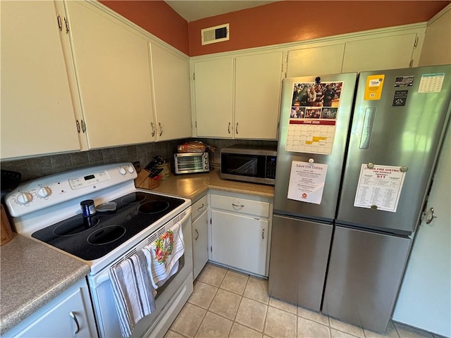 46 Dickerson St, Lyons, NY 14489 - kitchen featuring appliances with stainless steel finishes, backsplash, and light tile patterned flooring