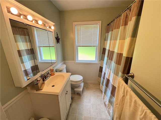 46 Dickerson St, Lyons, NY 14489 - full bath featuring toilet, a wainscoted wall, vanity, plenty of natural light, and tile patterned flooring