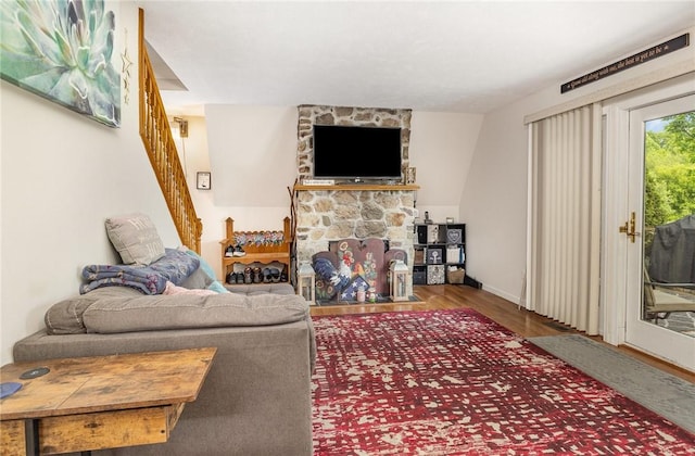 2703 Lembke Rd, Arcadia, NY 14489 - living room featuring stairway, wood finished floors, a fireplace, and baseboards