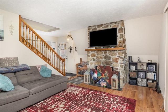 2703 Lembke Rd, Arcadia, NY 14489 - living area with stairs, wood finished floors, and a fireplace