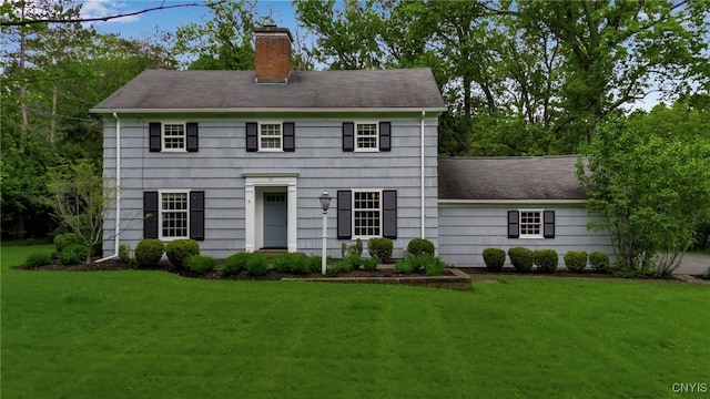 11 S Meadow Dr, Orchard Park, NY 14127 - colonial-style house featuring a chimney, a front yard, and a shingled roof