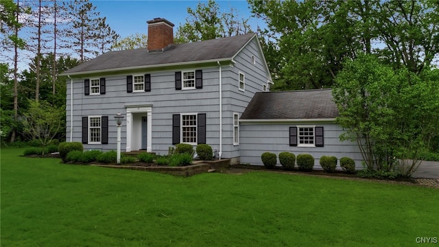 11 S Meadow Dr, Orchard Park, NY 14127 - colonial house with a chimney, a front lawn, and roof with shingles