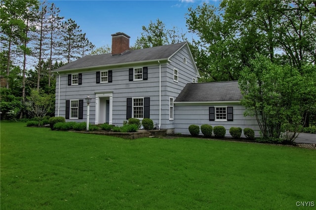 11 S Meadow Dr, Orchard Park, NY 14127 - colonial house featuring a chimney, a front lawn, and roof with shingles