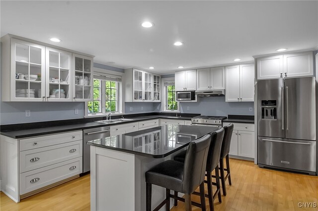 11 S Meadow Dr, Orchard Park, NY 14127 - kitchen featuring stainless steel appliances, under cabinet range hood, light wood-style floors, a breakfast bar area, and recessed lighting