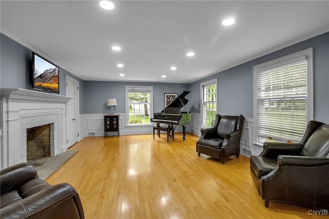 11 S Meadow Dr, Orchard Park, NY 14127 - living room with crown molding, light wood finished floors, recessed lighting, a fireplace, and a decorative wall