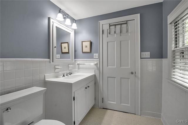 11 S Meadow Dr, Orchard Park, NY 14127 - bathroom featuring tile walls, vanity, and a wainscoted wall