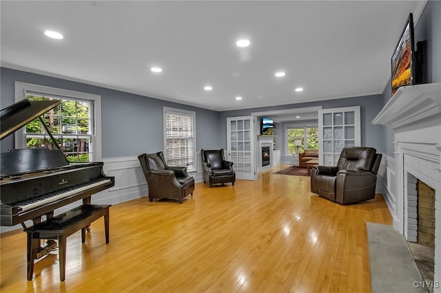 11 S Meadow Dr, Orchard Park, NY 14127 - living area with a fireplace with flush hearth, plenty of natural light, wainscoting, a decorative wall, and recessed lighting
