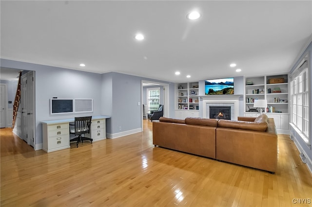 11 S Meadow Dr, Orchard Park, NY 14127 - living room with an office area, a tile fireplace, light wood-style floors, recessed lighting, and built in shelves