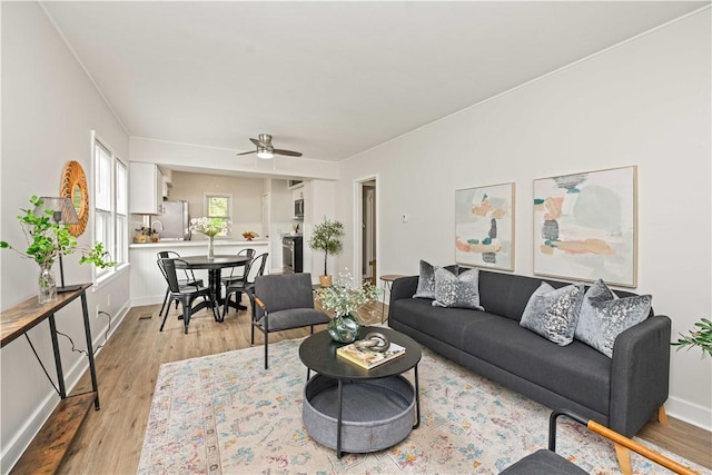 131 Pomona Dr, Greece, NY 14616 - living room with light wood-style flooring, a ceiling fan, and baseboards