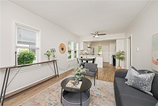 131 Pomona Dr, Greece, NY 14616 - living room featuring light wood-type flooring, ceiling fan, and baseboards