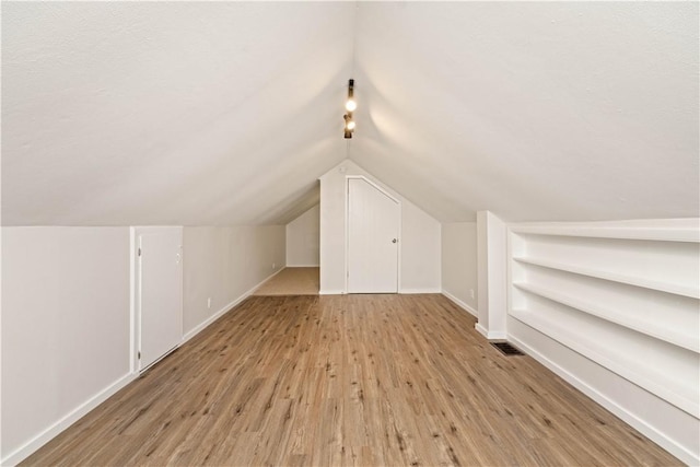 131 Pomona Dr, Greece, NY 14616 - bonus room featuring wood finished floors, baseboards, and vaulted ceiling
