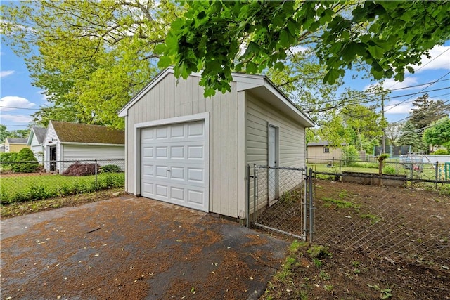 131 Pomona Dr, Greece, NY 14616 - detached garage with asphalt driveway and a gate