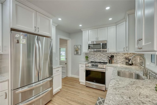 261 Hager Rd, Greece, NY 14616 - kitchen featuring appliances with stainless steel finishes, a sink, backsplash, light wood-style flooring, and recessed lighting