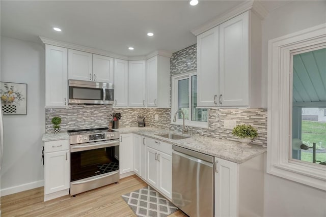 261 Hager Rd, Greece, NY 14616 - kitchen with appliances with stainless steel finishes, a sink, tasteful backsplash, light wood-type flooring, and white cabinetry