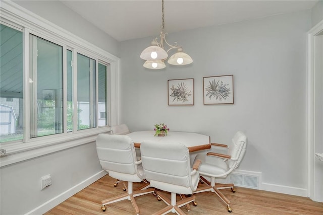 261 Hager Rd, Greece, NY 14616 - dining room with plenty of natural light, baseboards, a chandelier, and wood finished floors