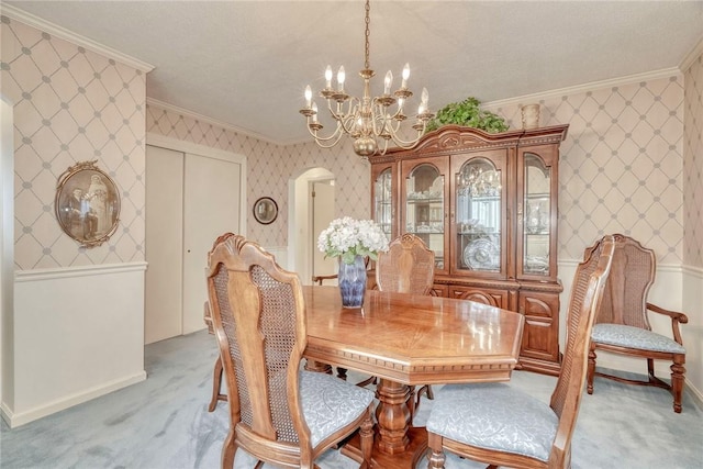 261 Hager Rd, Greece, NY 14616 - dining space featuring crown molding, a chandelier, light colored carpet, wallpapered walls, and baseboards