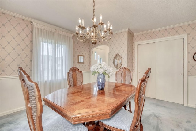 261 Hager Rd, Greece, NY 14616 - dining room featuring crown molding, a chandelier, carpet, wallpapered walls, and arched walkways