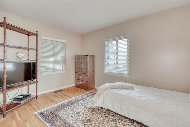 261 Hager Rd, Greece, NY 14616 - bedroom featuring wood finished floors, multiple windows, and baseboards