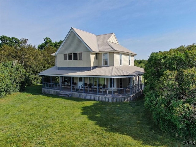 3180 Carleton Island Rd Unit 1, Cape Vincent, NY 13618 - rear view of house with metal roof and a yard
