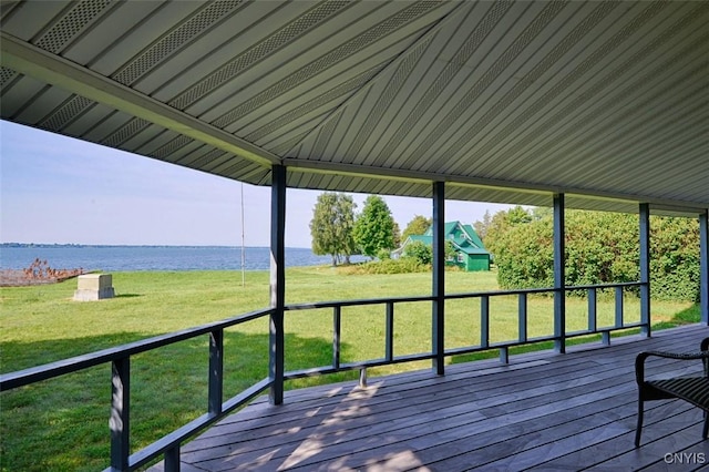 3180 Carleton Island Rd Unit 1, Cape Vincent, NY 13618 - deck featuring a water view and a lawn
