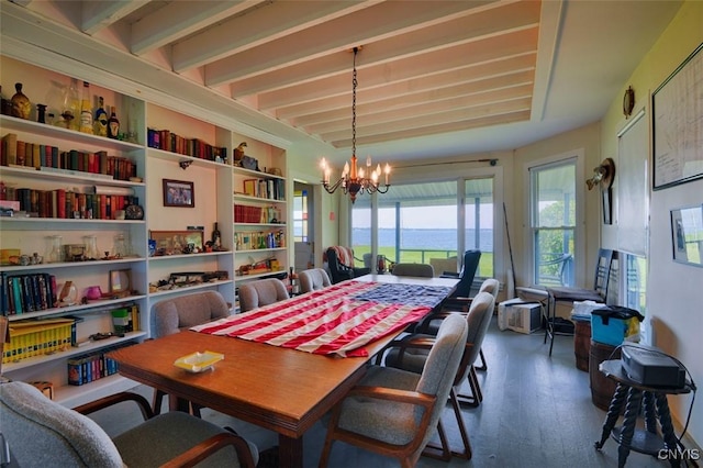 3180 Carleton Island Rd Unit 1, Cape Vincent, NY 13618 - dining space featuring a chandelier, wood finished floors, beam ceiling, and a water view