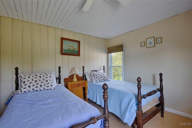 3180 Carleton Island Rd Unit 1, Cape Vincent, NY 13618 - bedroom featuring baseboards, wood finished floors, wood walls, wooden ceiling, and a ceiling fan