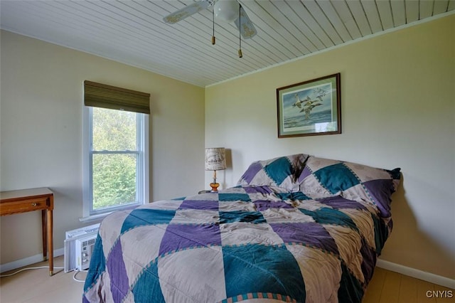 3180 Carleton Island Rd Unit 1, Cape Vincent, NY 13618 - bedroom with baseboards, wood ceiling, a ceiling fan, and an AC wall unit
