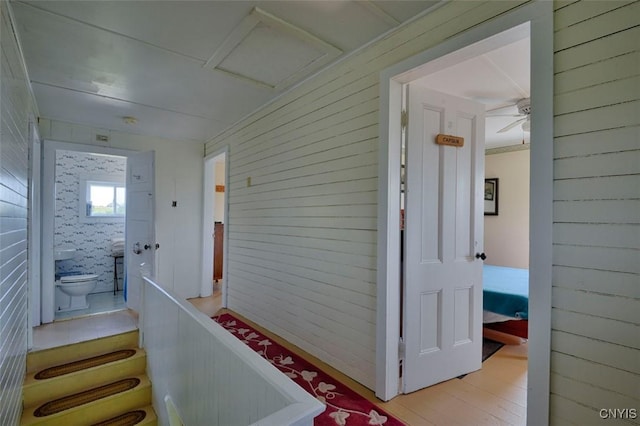 3180 Carleton Island Rd Unit 1, Cape Vincent, NY 13618 - hall with wood walls, an upstairs landing, and wood finished floors