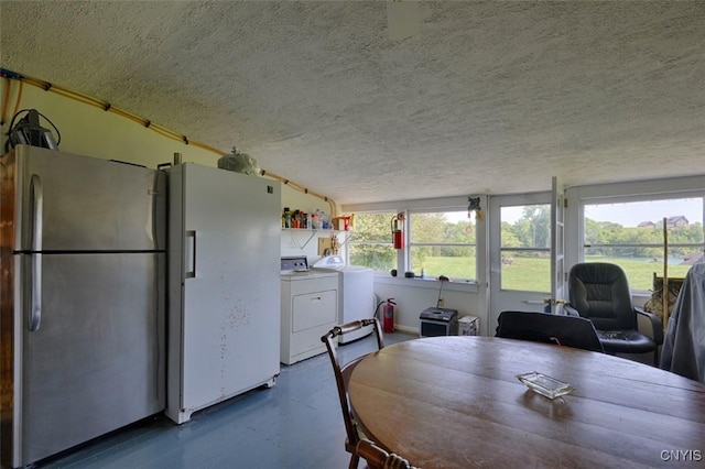 3180 Carleton Island Rd Unit 1, Cape Vincent, NY 13618 - dining area with a textured ceiling, concrete floors, and washing machine and dryer
