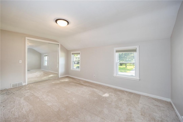 1711 N Winton Rd, Irondequoit, NY 14609 - carpeted spare room featuring lofted ceiling, baseboards, and plenty of natural light