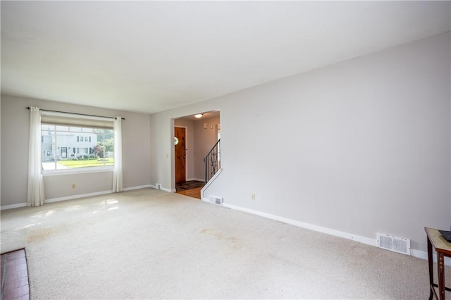 1711 N Winton Rd, Irondequoit, NY 14609 - spare room with carpet, baseboards, and stairway