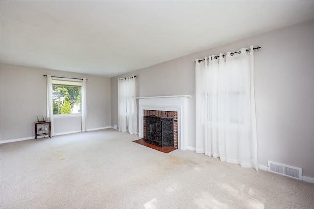 1711 N Winton Rd, Irondequoit, NY 14609 - unfurnished living room with a brick fireplace, carpet, and baseboards