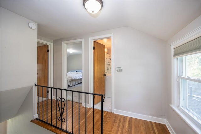 1711 N Winton Rd, Irondequoit, NY 14609 - hall with wood finished floors, vaulted ceiling, and baseboards