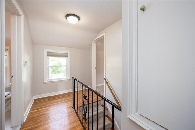 1711 N Winton Rd, Irondequoit, NY 14609 - hallway featuring an upstairs landing, lofted ceiling, light wood-type flooring, and baseboards