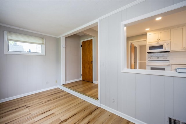 1711 N Winton Rd, Irondequoit, NY 14609 - empty room with light wood-type flooring, baseboards, and ornamental molding