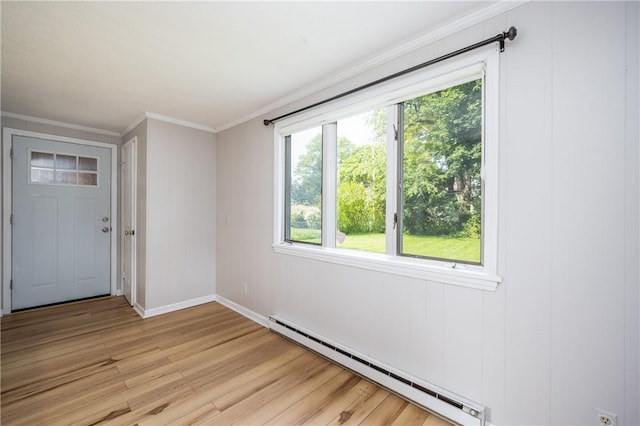 1711 N Winton Rd, Irondequoit, NY 14609 - spare room featuring a baseboard heating unit, light wood-style floors, crown molding, and baseboards
