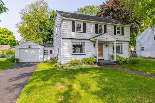 1711 N Winton Rd, Irondequoit, NY 14609 - colonial inspired home featuring an outdoor structure, a chimney, a front lawn, asphalt driveway, and a garage