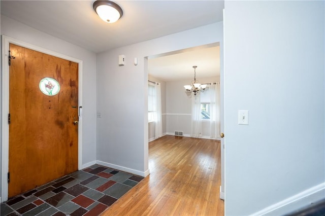1711 N Winton Rd, Irondequoit, NY 14609 - foyer entrance featuring a chandelier, baseboards, and wood finished floors