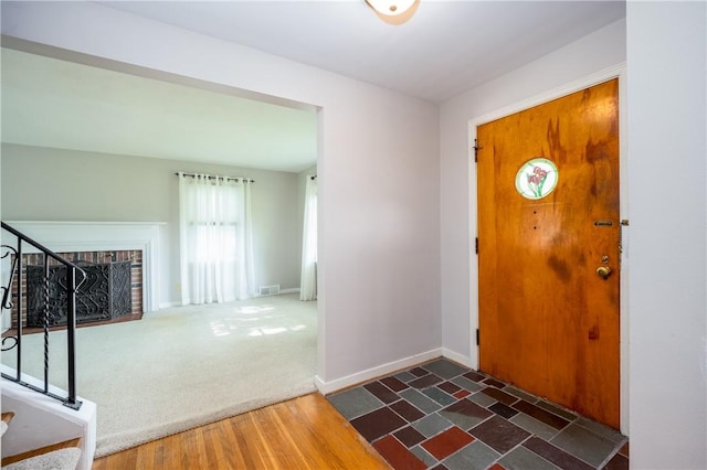 1711 N Winton Rd, Irondequoit, NY 14609 - foyer entrance with stairway, wood finished floors, and baseboards