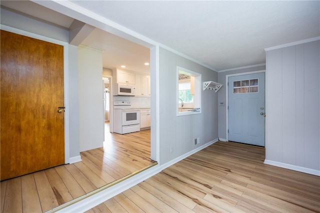 1711 N Winton Rd, Irondequoit, NY 14609 - foyer entrance featuring light wood-style floors, crown molding, and baseboards
