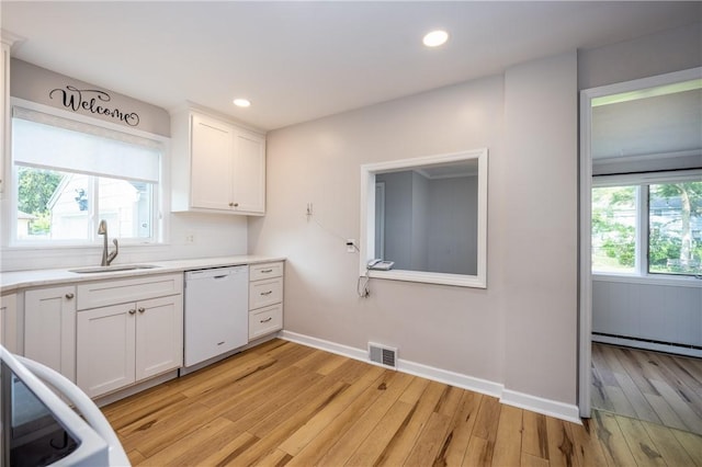 1711 N Winton Rd, Irondequoit, NY 14609 - kitchen featuring dishwasher, a sink, light wood-style floors, light countertops, and baseboard heating