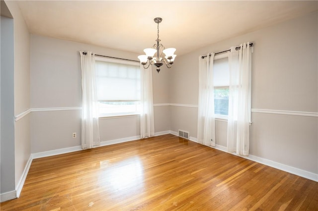 1711 N Winton Rd, Irondequoit, NY 14609 - unfurnished room featuring a chandelier, light wood-style floors, and baseboards