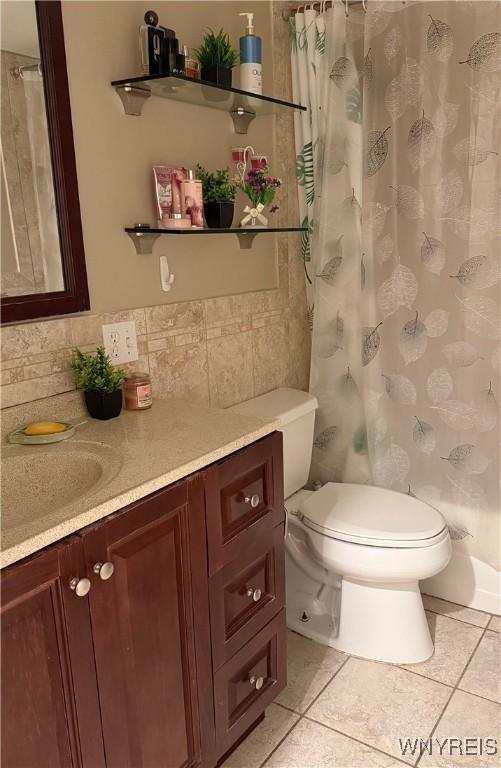 4547 Chestnut Ridge Rd Unit 104B, Amherst, NY 14228 - bathroom featuring toilet, vanity, tile patterned flooring, and a shower with curtain