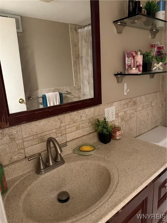 4547 Chestnut Ridge Rd Unit 104B, Amherst, NY 14228 - bathroom featuring backsplash and vanity