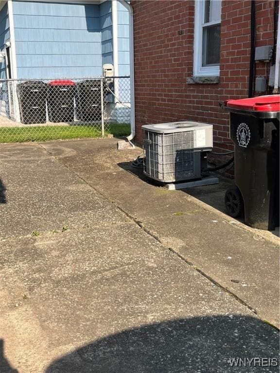 118 Erie St, Lancaster, NY 14086 - exterior view of central air condition unit and brick siding