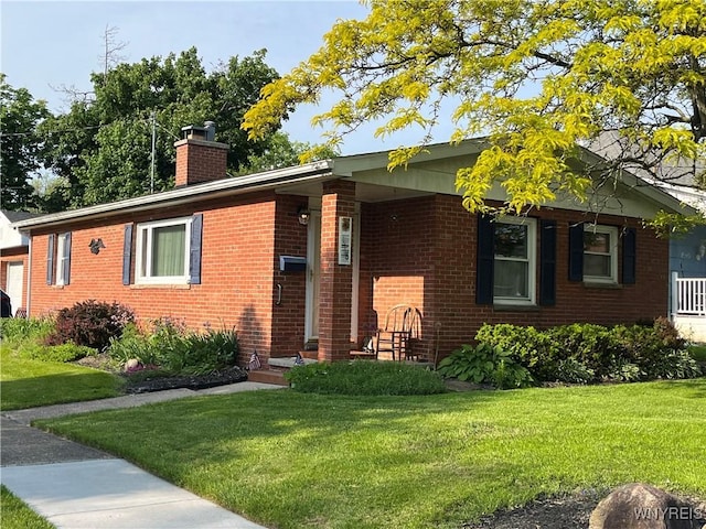 118 Erie St, Lancaster, NY 14086 - single story home with brick siding, a front yard, and a chimney