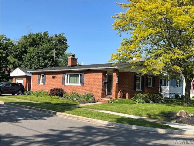 118 Erie St, Lancaster, NY 14086 - single story home with a chimney, brick siding, a front yard, and a garage